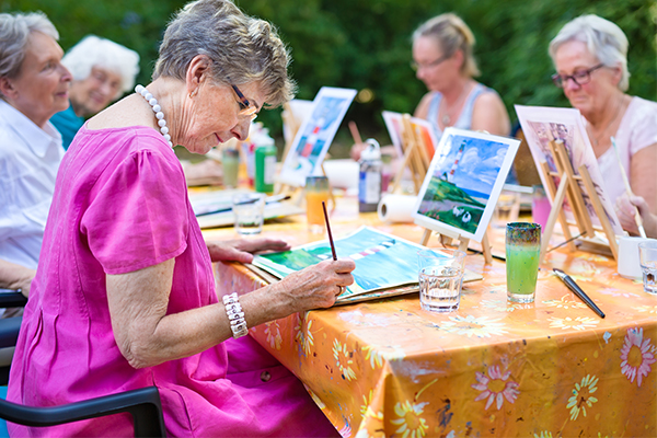 An image of a group of elderly people painting